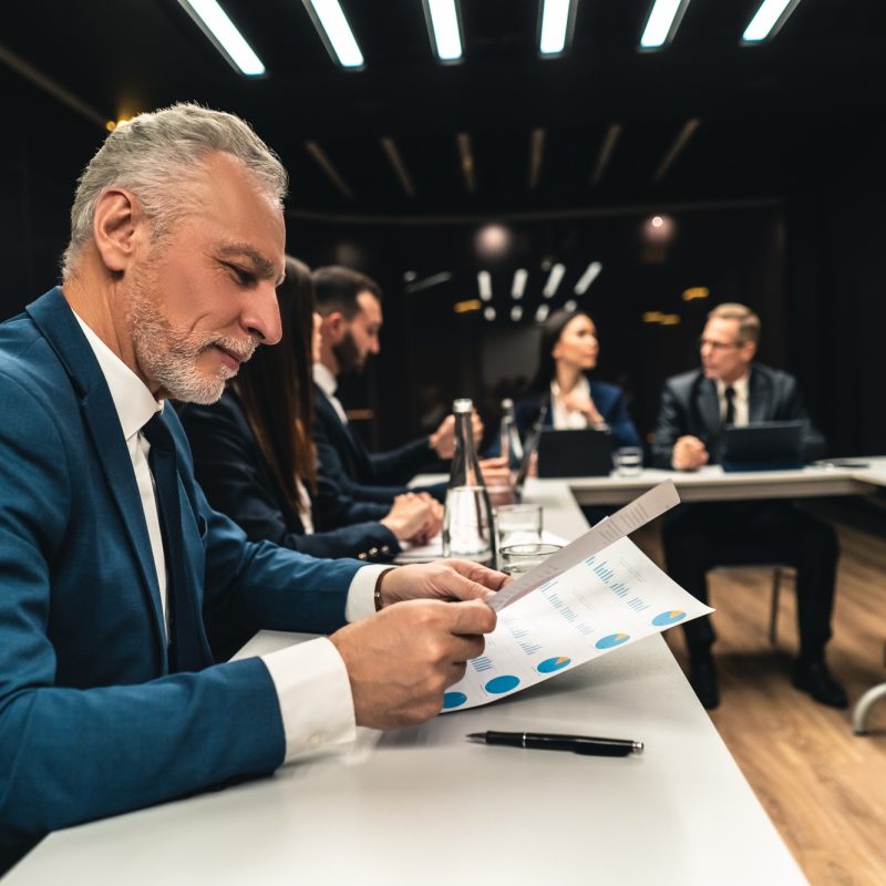 The business people at the meeting.